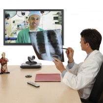 Doctor speaking with surgeon via Lifesize Video Conferencing, holding xray and showing to far end surgeon.