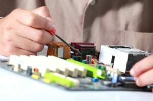 Close up circuit board and man making components